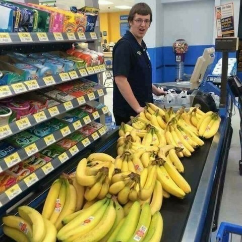 check out guy at Walmart looking absolutely perturbed at the sheer number of bananas that somebody is ringing up