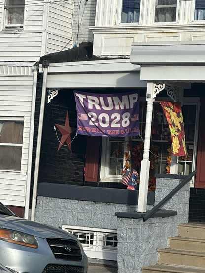 big flag on someone's porch in Philly that says TRUMP 2028: REWRITE THE RULES
