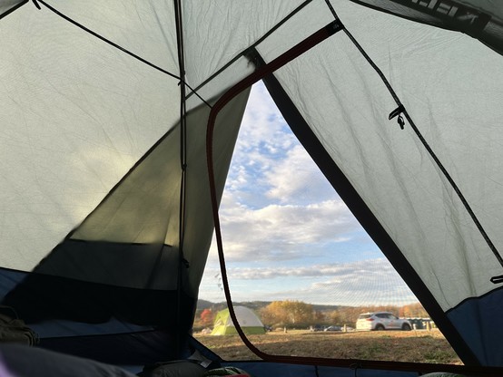 view of the sky framed by the entrance to the tent im in 