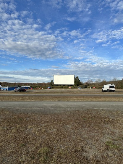 the drive in movie screen with the frickin big blue sky behind it 