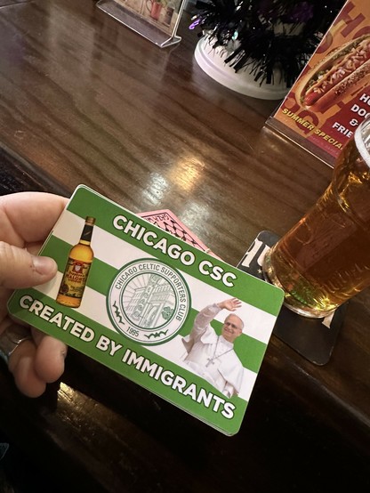 sticker that has a picture of the pope and a bottle of malort and says CHICAGO CSC / CREATED BY IMMIGRANTS 
