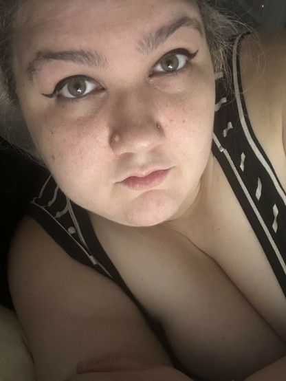 selfie of me in winged eyeliner trying my best to keep it together 