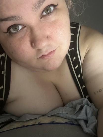 selfie of me in winged eyeliner trying my best to keep it together but looking cute at least 