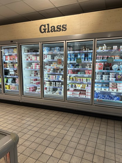 glass-doored freezers at a grocery store in Sweden with a big sign above them that says "Glass"

(it's the Swedish word for ice cream)