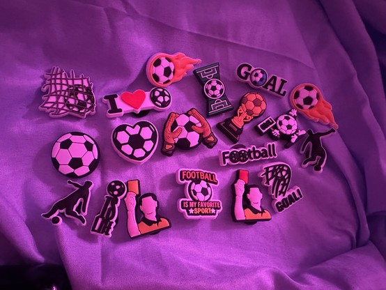 assortment of pretty generic football croc charms but they're very cute. got a yellow card and a red card and I heart football and football is my favorite sport and a football in the shape of a heart and stuff 