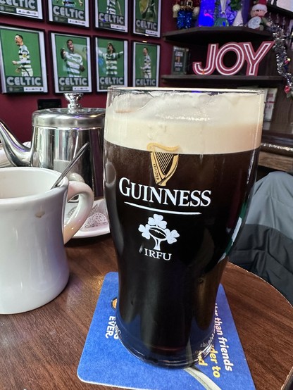 I'm having a pint of guinness at the pub and there's a Christmas sign in the background that says JOY