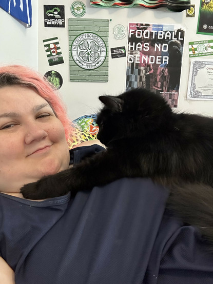 my cat sitting on my chest putting a paw on my chin 