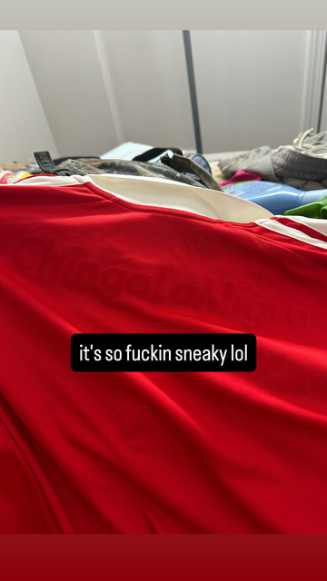 back of my red chicago fire kit with almost the exact same shade of red decal that says Chinga La Migra. it's barely perceptible unless the light catches it the right way so you can see the decal texture