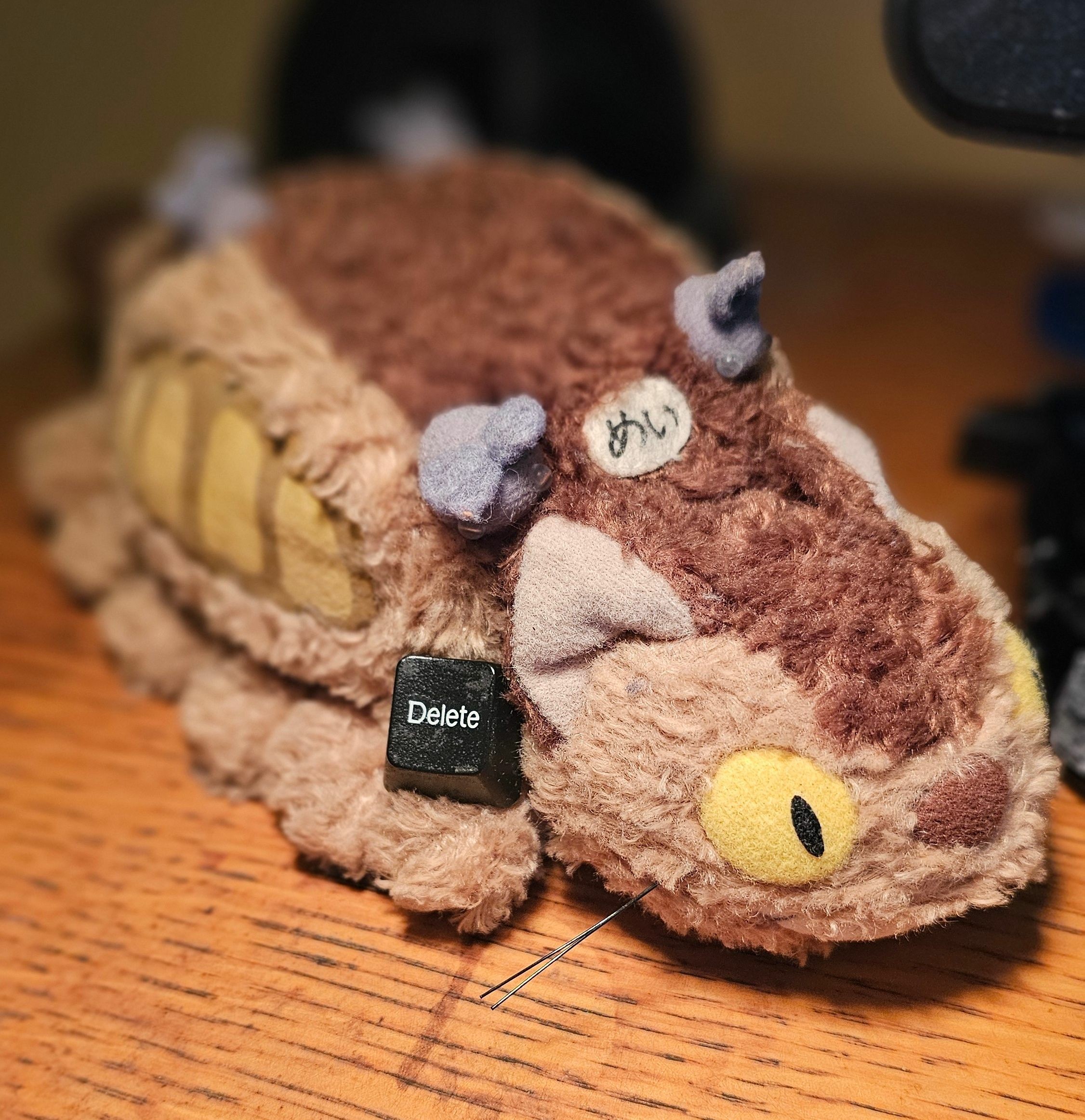 stuffed Catbus with a Delete key in one paw